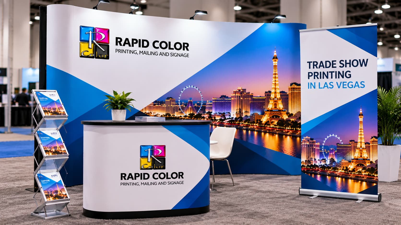 Rapid Color trade show printing booth in Las Vegas with branded banners, backdrop, table throw, brochures, signage, and promotional displays.